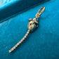 Hand-sculpted 14K gold rat charm with articulated segmented vintage diamond eternity bracelet tail, photographed on dark velvet showing full body and tail movement