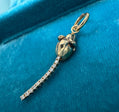 Hand-sculpted 14K gold rat charm with articulated segmented vintage diamond eternity bracelet tail, photographed on dark velvet showing full body and tail movement