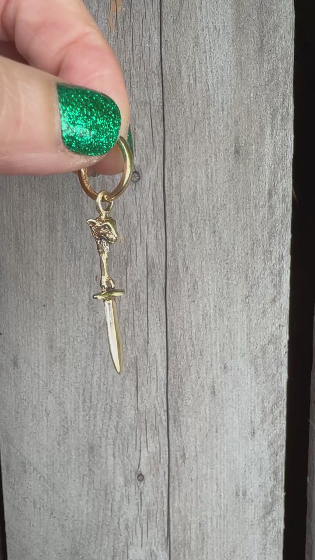 video of 14K lamb bones and sword earring in 14K gold by anomaly Relic. made by hand in New York City