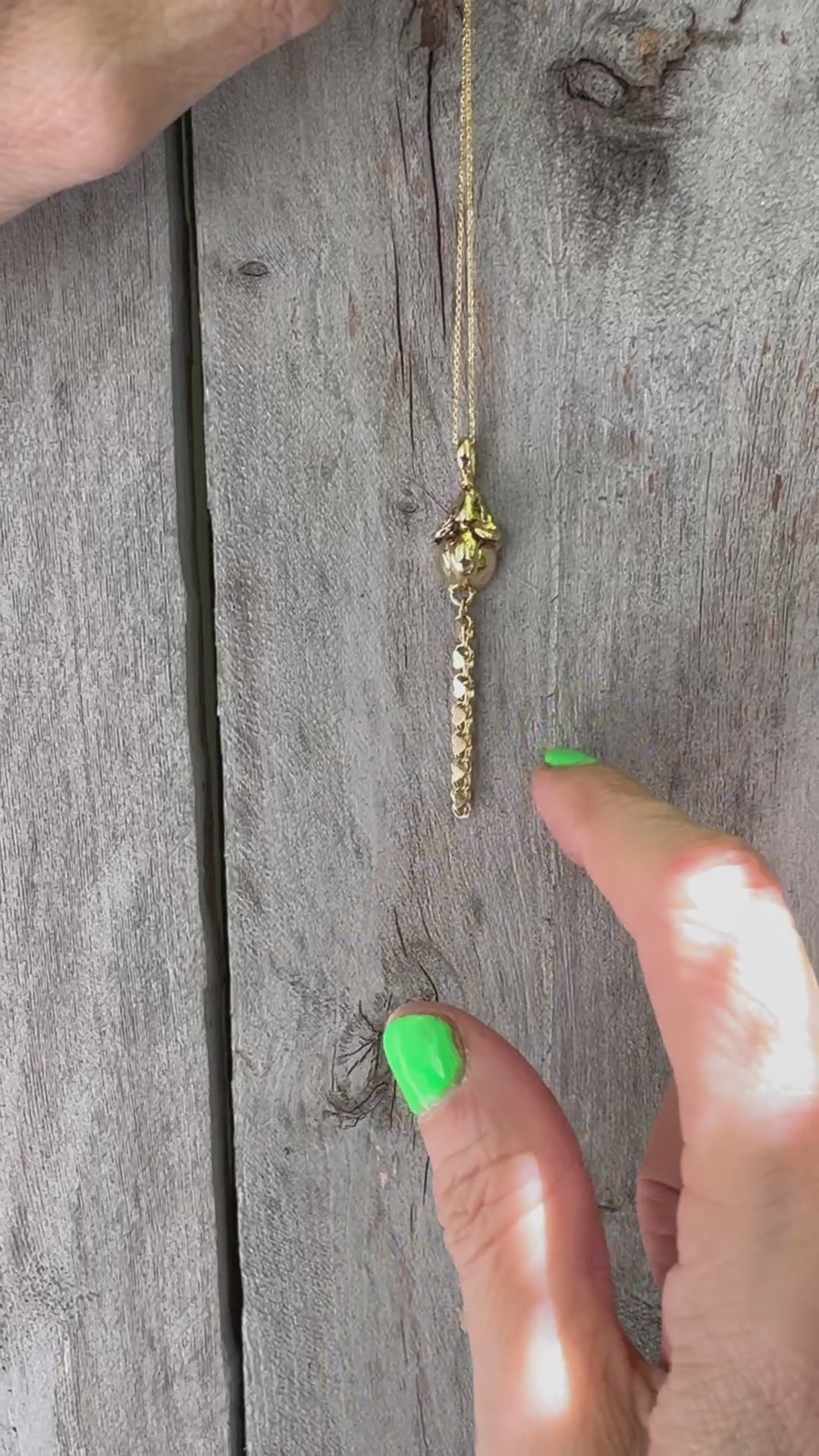 A 14k gold rat pendant necklace featuring a small heart-shaped chain tail with a dangling, articulated heart-link chain