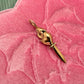 14K gold rat charm with a sword for its tail