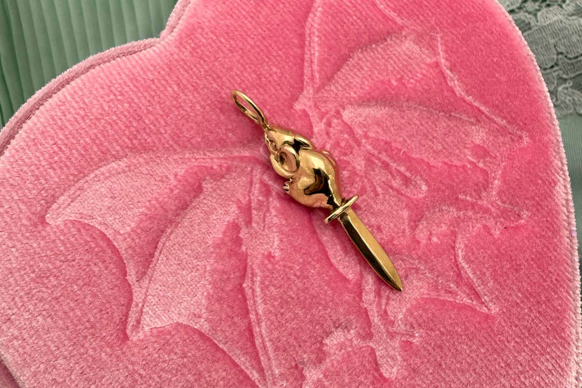 14K gold rat charm with a sword for its tail